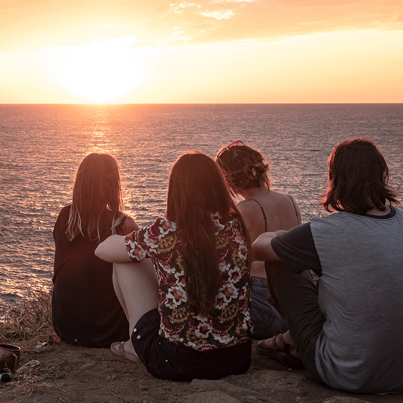 Group of teenagers on the beach watching the sunset. Teen therapy in Pacifica