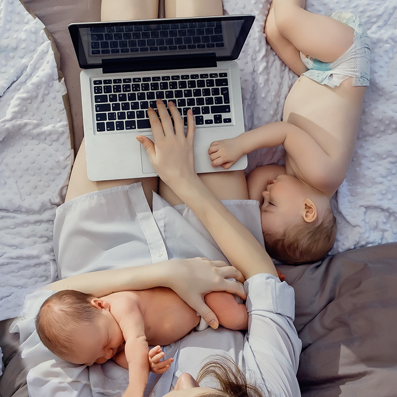 Mom of twins on a laptop preparing for therapy for moms