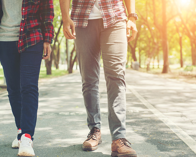 Two people walking side by side showing the benefit of walking therapy